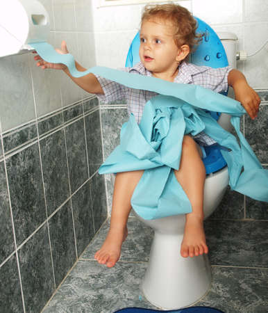 little baby sitting on the toiltetの写真素材