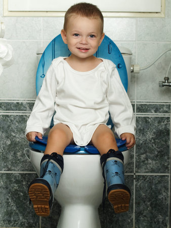 little baby sitting on the toiltetの写真素材