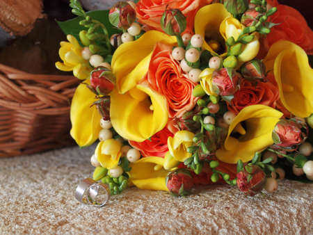 still life with wedding bouquet and wedding ringsの写真素材