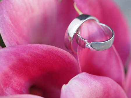 still life with wedding bouquet and wedding ringsの写真素材