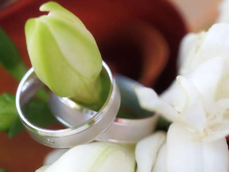 still life with wedding bouquet and wedding ringsの写真素材