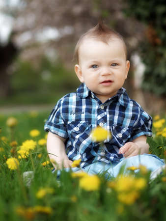 little boy playing in the park in the springの写真素材