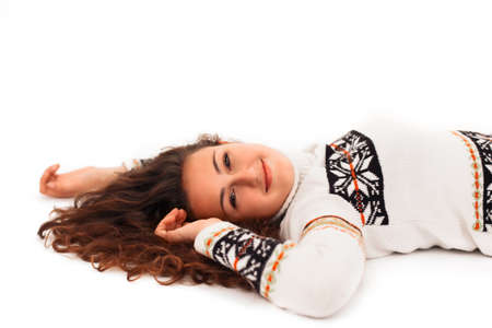 Young Girl with Curly Hair in a Sweater Lies on White Isolated Background
