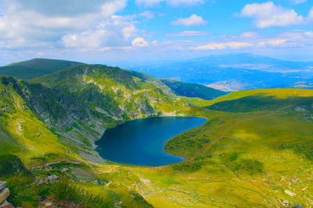 Panoramic picture of a high mountain lake in a sunny dayの写真素材