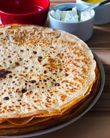 food Pancakes with local bee honey white cheese and tea and spoons closeupの写真素材