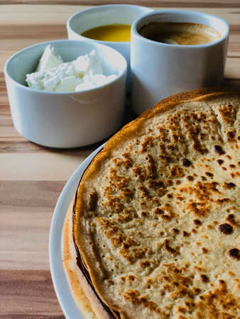 food Pancakes with local bee honey white cheese and black coffee closeの写真素材