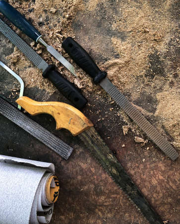 Tools sandpaper wood saw rasping outdoors labor craft concept