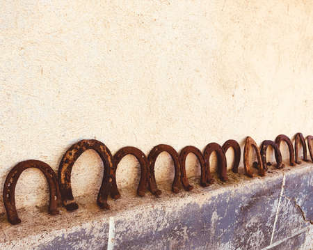 rusty horseshoes on a wall collected good luck conceptの写真素材