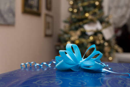 Christmas gift with a tree in the backgroundの写真素材