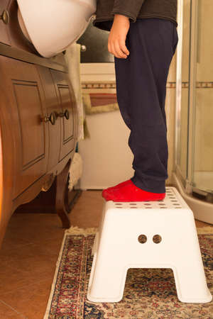 close up baby over stool in bathroomの写真素材