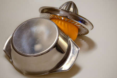 Still life juicer and orange with white background