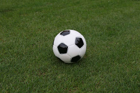 Closeup view of soccer ball on green fieldの写真素材