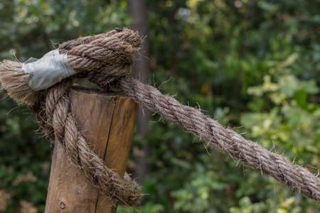 closeup of an old rope tied to the poleの写真素材