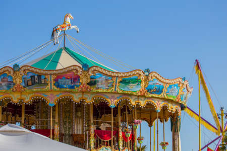ancient game horse carousel with many fliers and decorations
