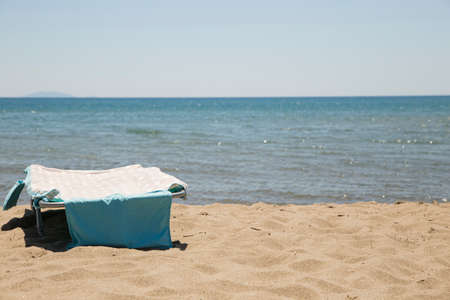 image of sun lounger on the beach with sea in the backgroundの写真素材