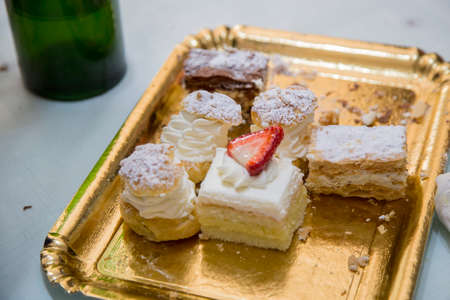 image of a golden cardboard tray with mixed pastries