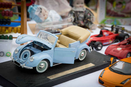image with detail of a model of turquoise decoupling car at flea market