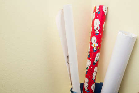 horizontal image of three rolls of gift paper in a basketの写真素材