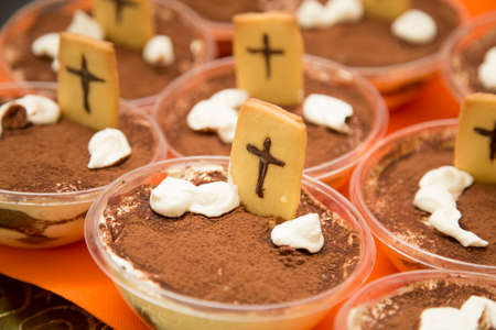 horizontal image with detail of chocolate sweets with cookies prepared for halloween partyの写真素材
