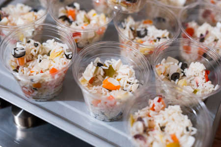 horizontal image with detail of various appetizers served in transparent plastic cupsの写真素材