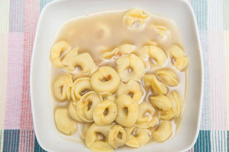 horizontal image with detail with top view of a plate of pasta in hot brothの写真素材