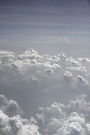 fluffy clouds going past an aeroplane window whilst on holidays