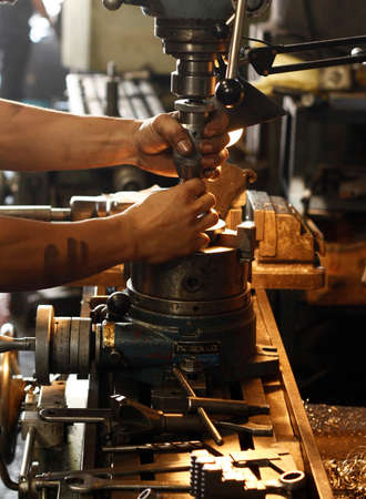 Metal engine parts being drilled, bored and lathed in a metal engineering workshop in Thailand, Southeast Asiaの写真素材