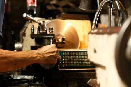 Metal engine parts being drilled, bored and lathed in a metal engineering workshop in Thailand, Southeast Asiaの写真素材
