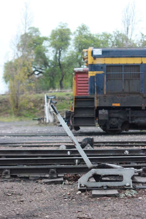 vintage steam rail linkage equipment at an operational railway museum with a diesel engine parked...