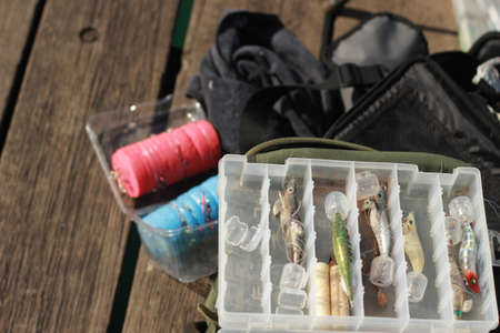 fishing paraphernalia sitting on the jetty. ie. fishing lines, floats, bait and tools, on a sunny afternoon, Victoria, Australiaの写真素材