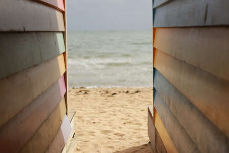 details of the colours and and vibrance of the Brighton beach huts along the beach on a summer sunny...