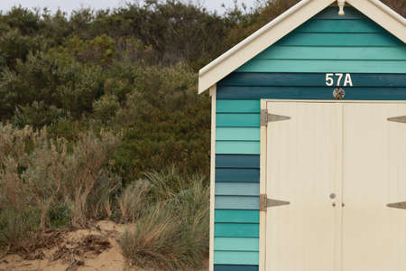 details of the colours and and vibrance of the Brighton beach huts along the beach on a summer sunny...