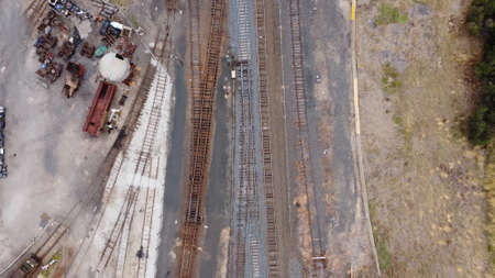 top down drone view of vintage railway tracks, sheds and carriagesの写真素材