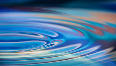 Colorful water ripples in a smooth pool of water