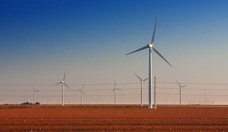 Wind Turbine farm in cotton fields in West Texas    High Voltage power lines also running through...