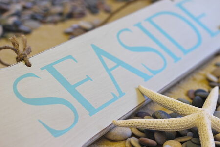 Seaside sign on beach backgroundの写真素材