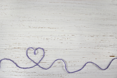 rustic distressed wood with yarn heart. White background. Copy Space.の写真素材