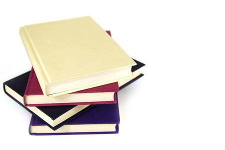 Pile of 4 plain covered books on white background. Copy space.