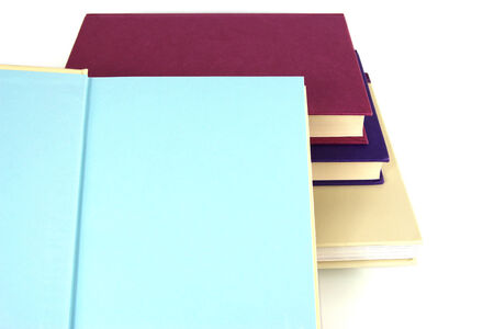 Pile of books, open book with blank pages. Copy Space on white background.の写真素材