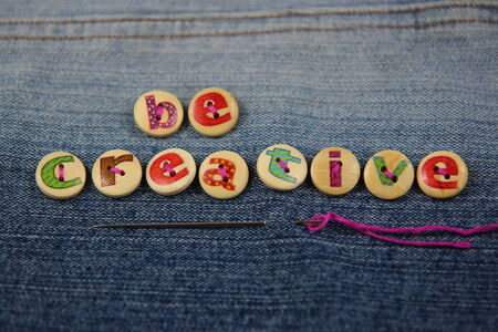 Be Creative spelled out in letterd buttonsの写真素材