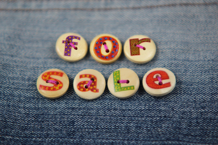 The words for sale spelled in lettered buttonsの写真素材