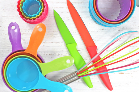 colorful kitchen utensils on white rustic backgroundの写真素材