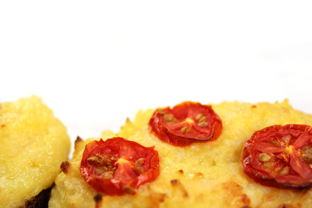 Close up of twice baked cheesy potatoes on white background with copy space.の写真素材