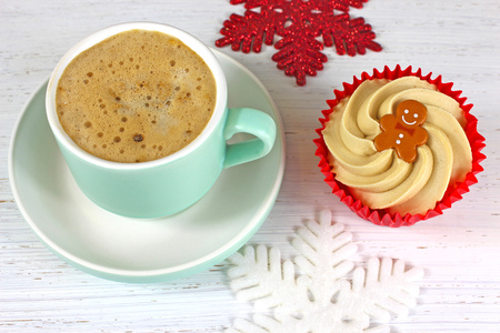 Holiday Coffee and cupcake on a rustic white wood background with glittering snowflake decorations.の写真素材