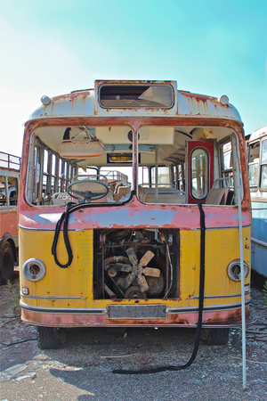 Colorful, rusted, broken down old bus.の写真素材