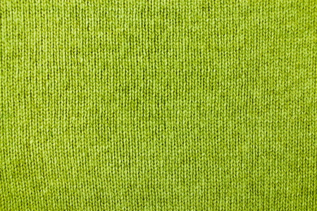 bright olive green knitted textile backgroundの写真素材