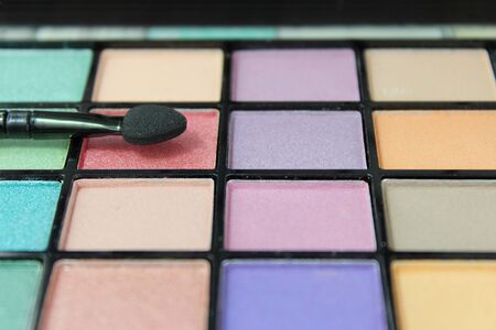 Eyeshadow make up palette with focus on applicator.の写真素材