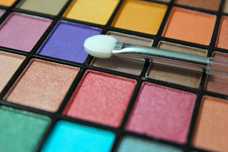 Colorful eyeshadow make up palette. Focus on make up appicator.の写真素材