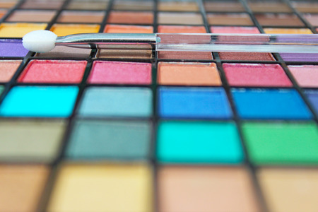 Vivid and colorful make up palette and applicator. Focus on the applicator wand.の写真素材