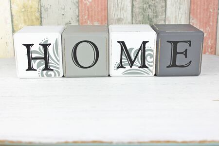 Home sign made from blocks on a distressed wood backgroundの写真素材
